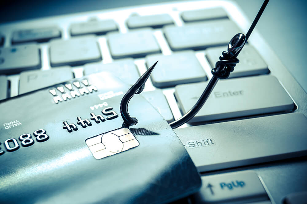 Photo of a fishing hook catching a credit card.