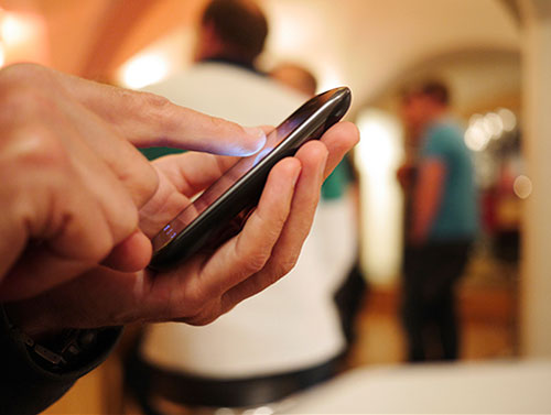 Man typing on a cell phone