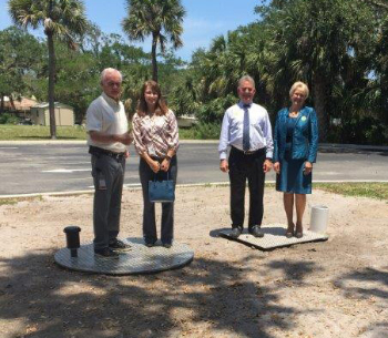 Marine bank employees standing in the parking lot on top of the sewer grates