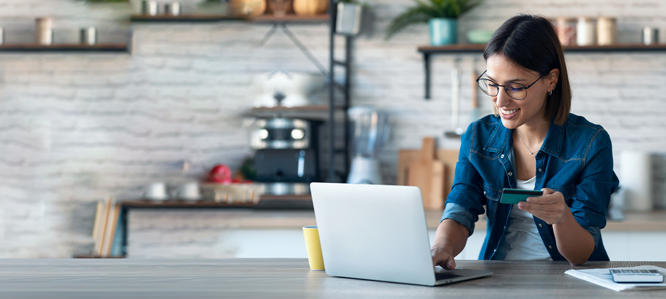 Woman looking at laptop and credit card